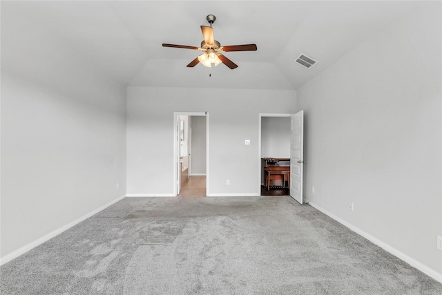 unfurnished bedroom featuring ceiling fan, light carpet, and vaulted ceiling