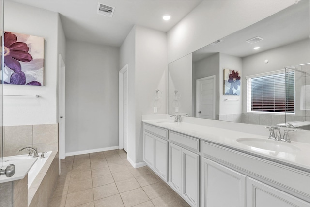 bathroom featuring vanity, tiled bath, and tile patterned floors