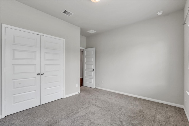 unfurnished bedroom featuring a closet and carpet