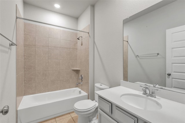 full bathroom with tile patterned flooring, vanity, toilet, and tiled shower / bath