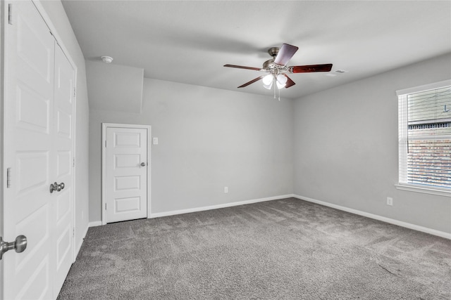 carpeted spare room featuring ceiling fan and a healthy amount of sunlight