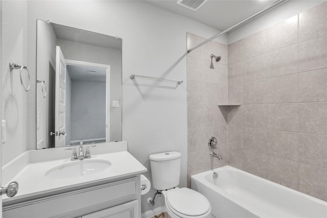 full bathroom featuring tiled shower / bath combo, toilet, and vanity