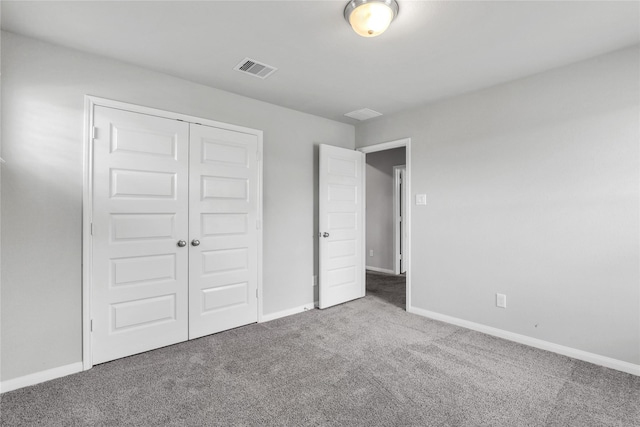 unfurnished bedroom featuring a closet and carpet