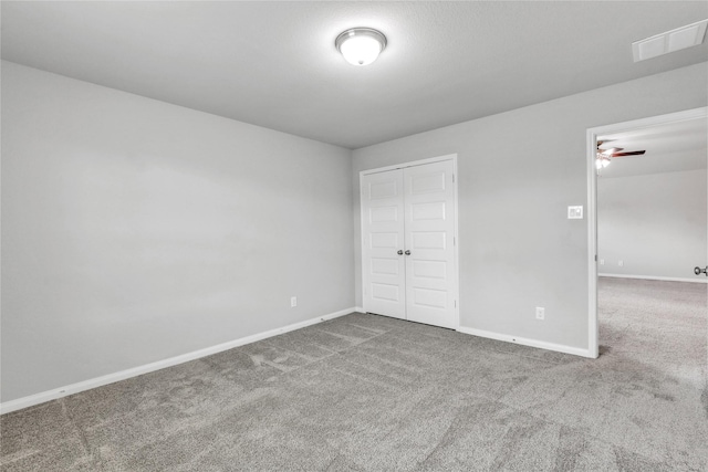 unfurnished bedroom featuring a closet and carpet