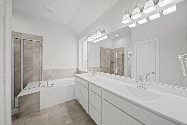 bathroom featuring vanity, separate shower and tub, lofted ceiling, and tile patterned floors