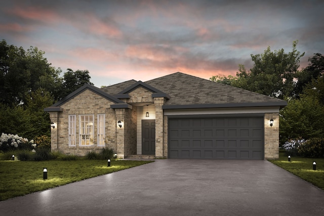 view of front of home featuring a garage and a lawn