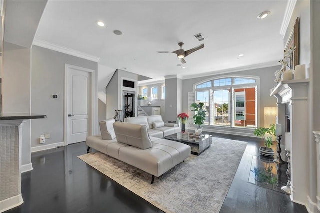 living room with ceiling fan, a fireplace, dark hardwood / wood-style floors, and ornamental molding