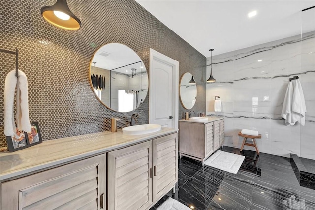 bathroom featuring vanity and tile walls