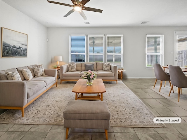 tiled living room with ceiling fan