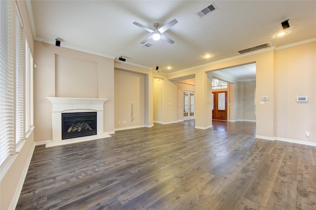 unfurnished living room with dark hardwood / wood-style flooring, ceiling fan, and ornamental molding