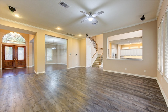 unfurnished living room with french doors, crown molding, and dark wood-type flooring