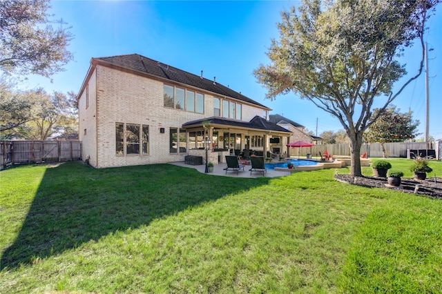 back of house featuring an outdoor living space, a patio area, a yard, and a fenced in pool