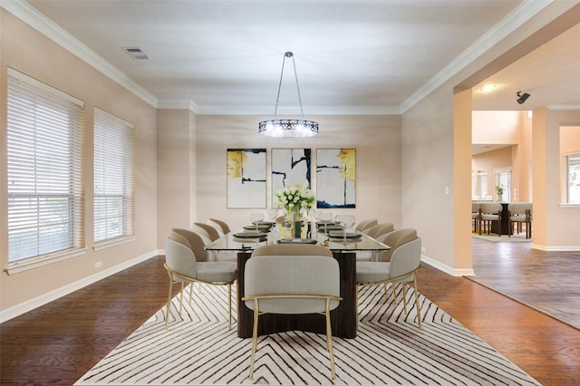 dining space with crown molding, a notable chandelier, and hardwood / wood-style flooring