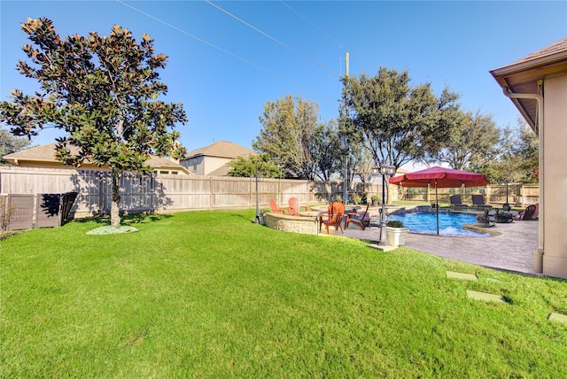 view of yard with a fire pit, a fenced in pool, and a patio