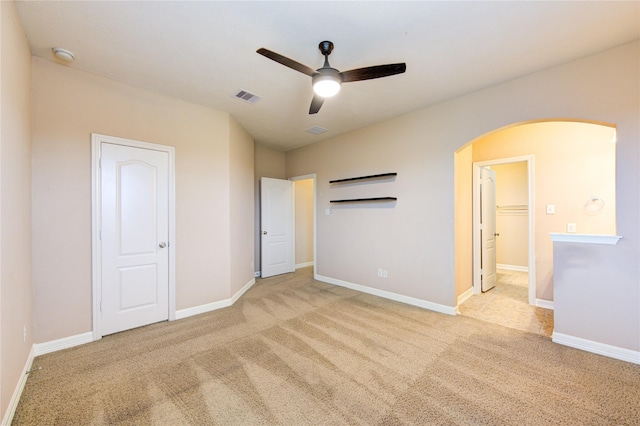 unfurnished bedroom with light colored carpet and ceiling fan