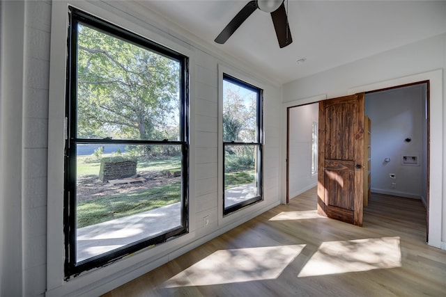 doorway to outside with ceiling fan and light hardwood / wood-style flooring