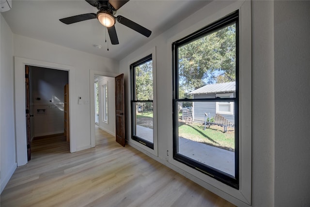 interior space featuring a wealth of natural light, ceiling fan, and light hardwood / wood-style floors