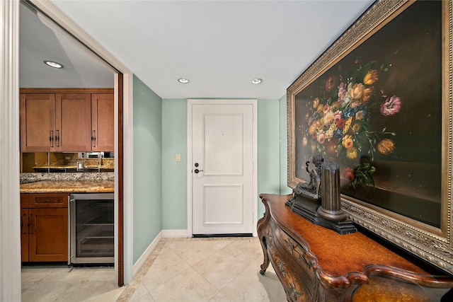 doorway featuring indoor bar, wine cooler, and light tile patterned flooring