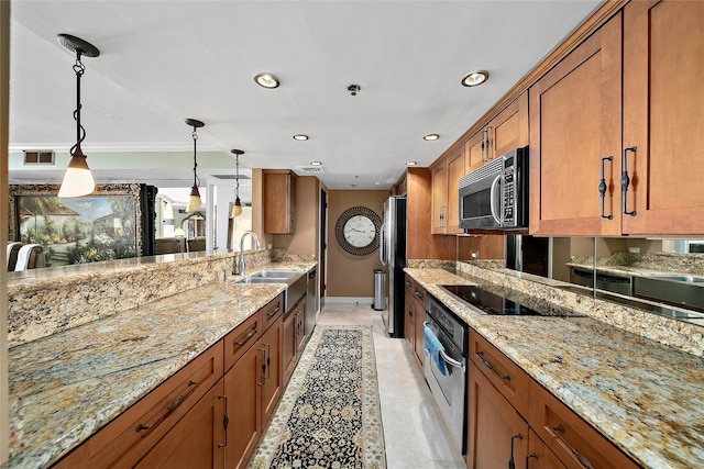 kitchen featuring sink, decorative light fixtures, light stone counters, and stainless steel appliances