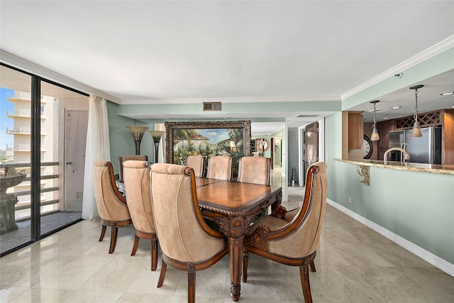 dining space featuring a wall of windows, ornamental molding, and sink