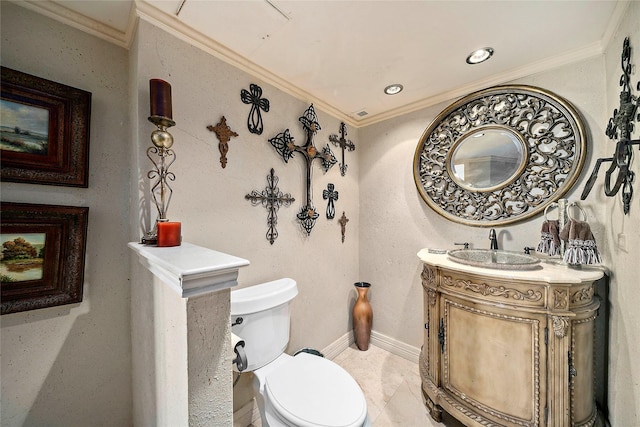 bathroom with toilet, vanity, and ornamental molding