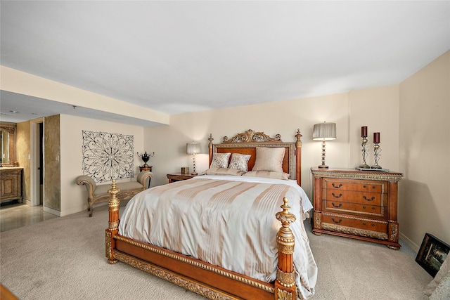 carpeted bedroom featuring ensuite bath