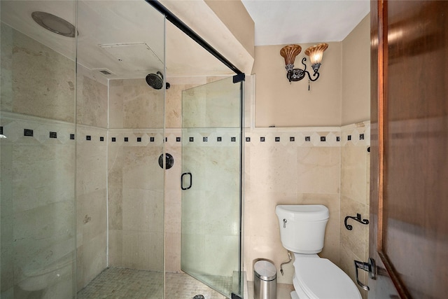 bathroom featuring toilet, tile walls, and walk in shower