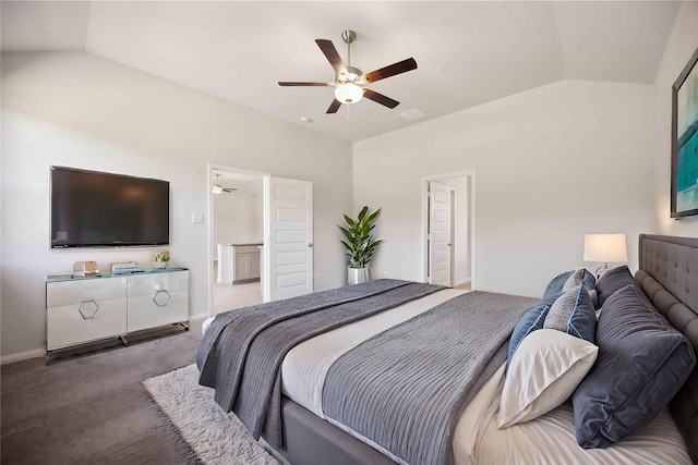 bedroom featuring carpet flooring, connected bathroom, vaulted ceiling, and ceiling fan