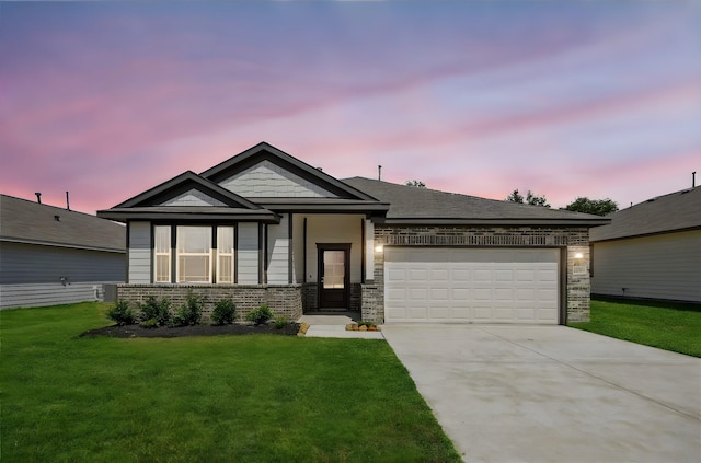 view of front facade featuring a lawn and a garage