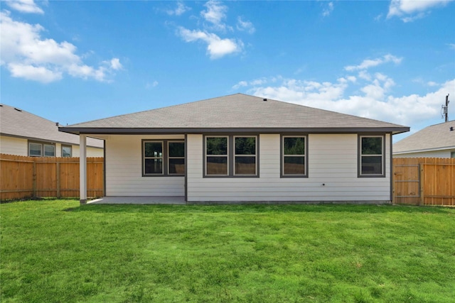 back of house featuring a yard