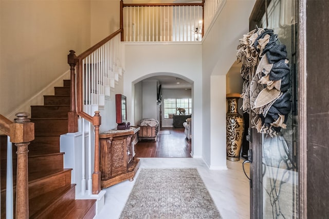 foyer entrance featuring a high ceiling and hardwood / wood-style flooring