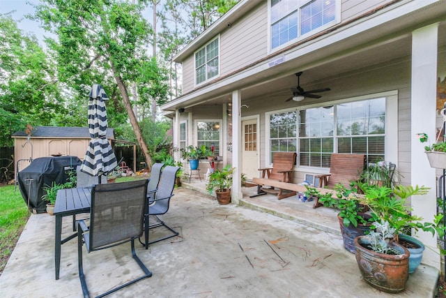 view of patio featuring ceiling fan, a shed, and grilling area