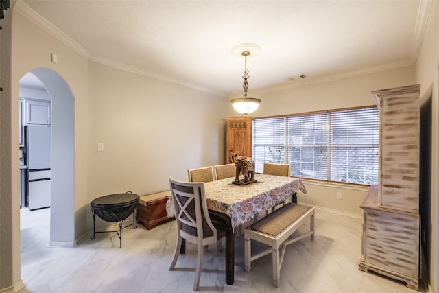 dining area with ornamental molding