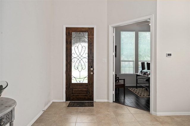 entryway with a wealth of natural light and light tile patterned flooring