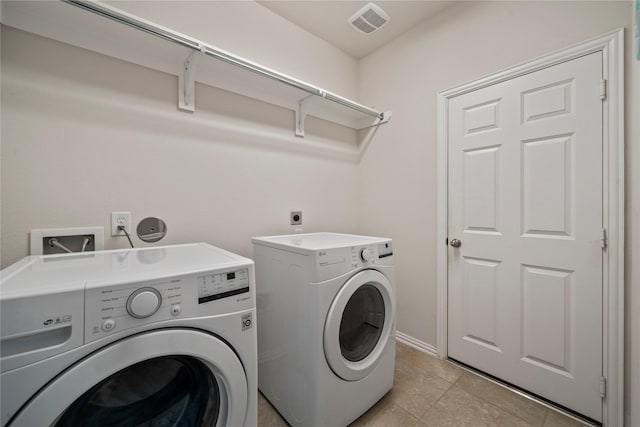 washroom with independent washer and dryer