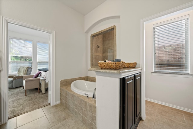 bathroom featuring tile patterned flooring and independent shower and bath