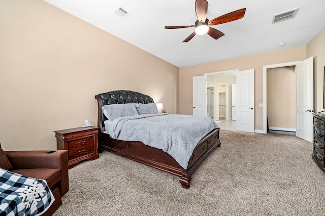 bedroom with ceiling fan and light carpet