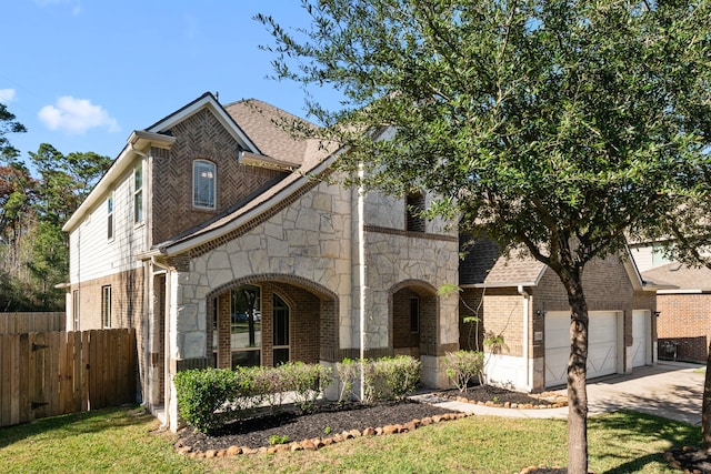 view of front of property with a garage and a front lawn