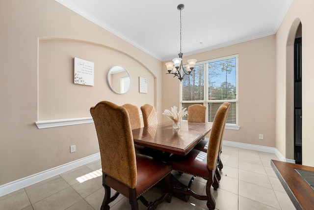 dining room with light tile patterned floors, an inviting chandelier, and crown molding