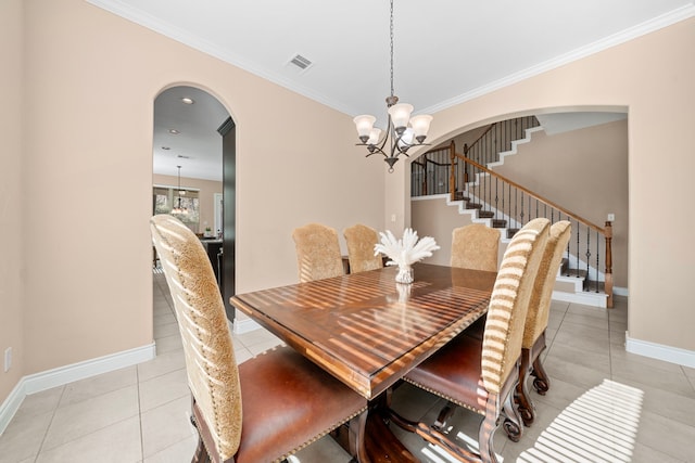 dining space featuring a chandelier, light tile patterned floors, and ornamental molding