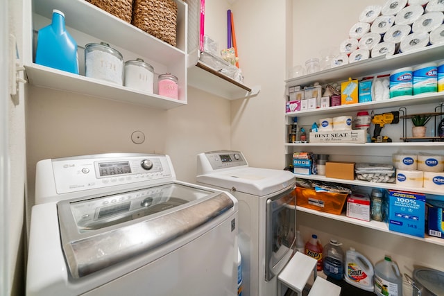 clothes washing area featuring washing machine and clothes dryer