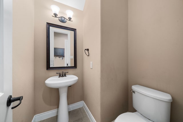 bathroom with toilet and tile patterned floors