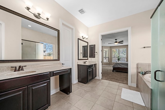 bathroom with a washtub, vanity, tile patterned flooring, and ceiling fan