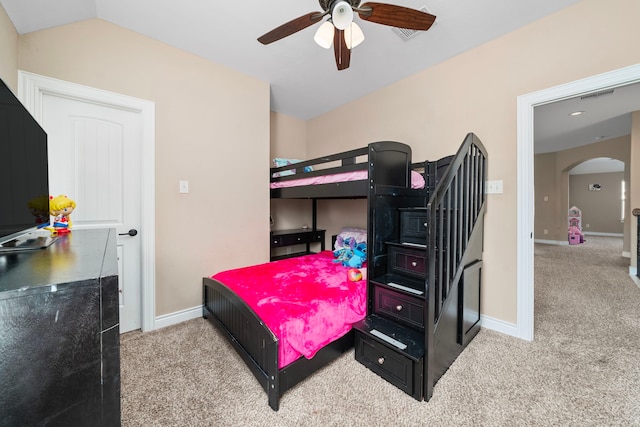 carpeted bedroom with ceiling fan and vaulted ceiling