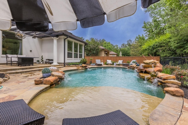 view of pool featuring pool water feature, a patio area, and central AC unit