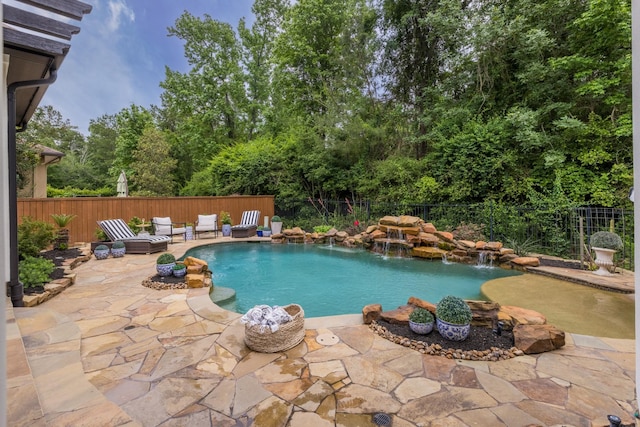 view of swimming pool with pool water feature and a patio area