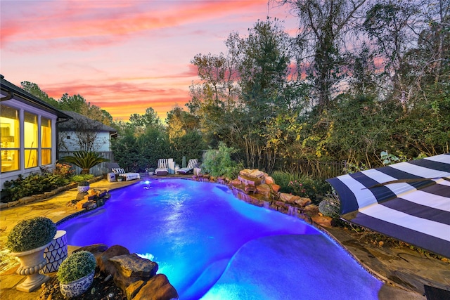 view of pool at dusk