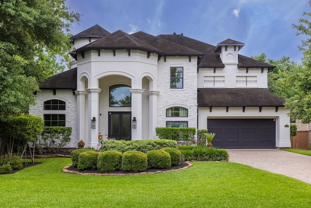 view of front facade with french doors, a front lawn, and a garage