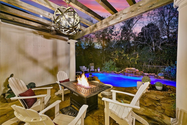 patio terrace at dusk with an outdoor fire pit, a fenced in pool, and a pergola