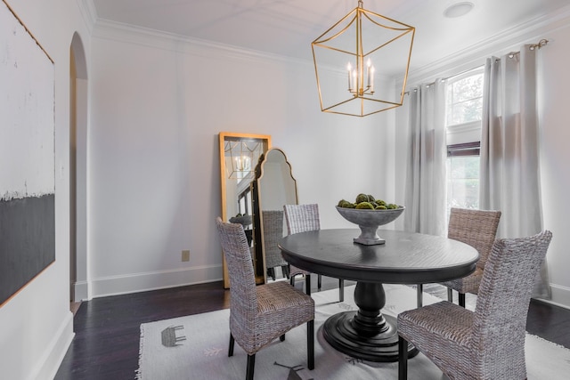 dining space with a chandelier, crown molding, and dark hardwood / wood-style floors